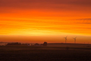 Beautiful orange sunrise with wind turbines, southwestern Minnesota.