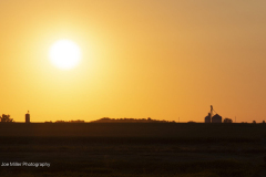 Grain bins and farm fields at sunrise, southwestern Minnesota.