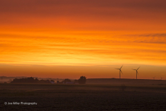 Beautiful orange sunrise with wind turbines, southwestern Minnesota.