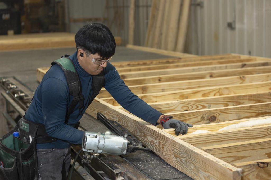 man working with nail gun